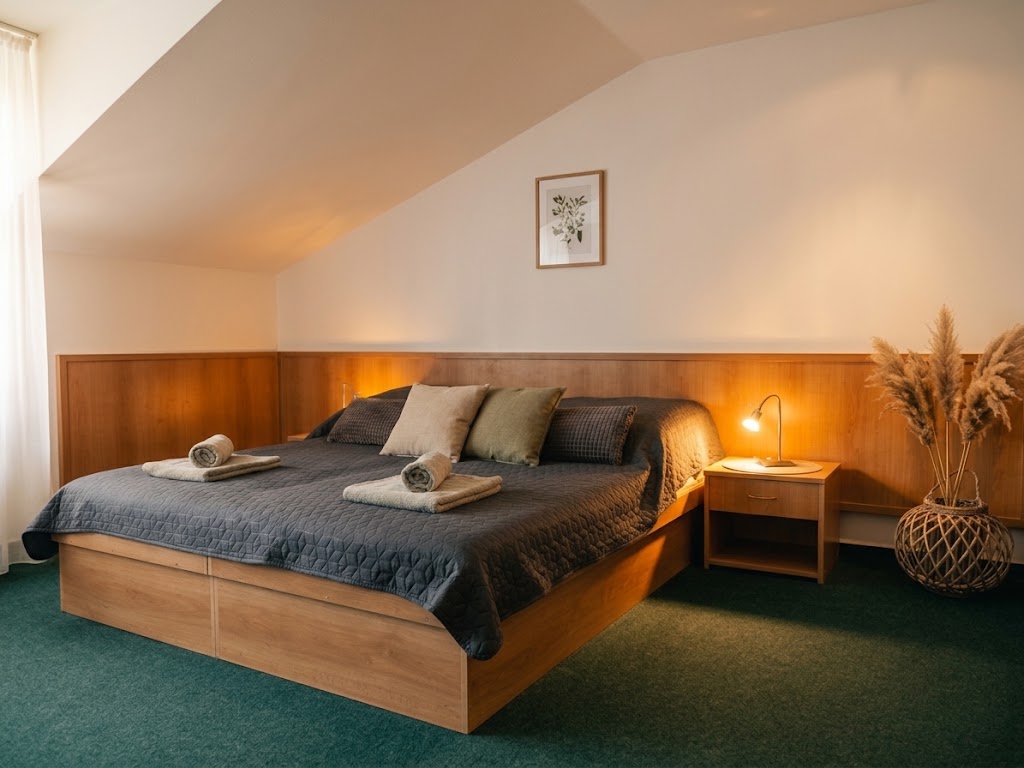Double room with a sofa at Ubytovanie KRAS